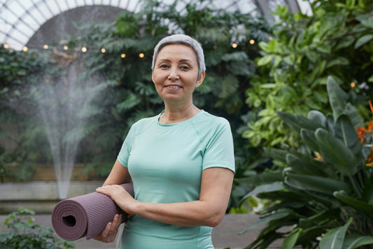 Woman holding gym mat