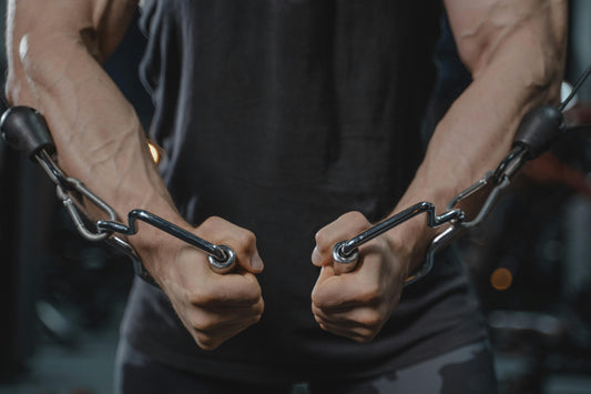 Person Stretching His Arms Using a Metal Chain